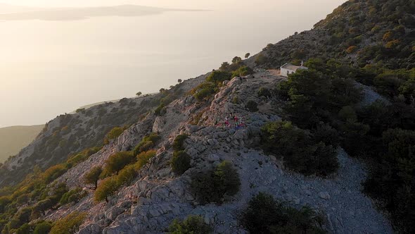 Aerial view of group practicing yoga at top of mountain, Veli Losinj, Croatia.