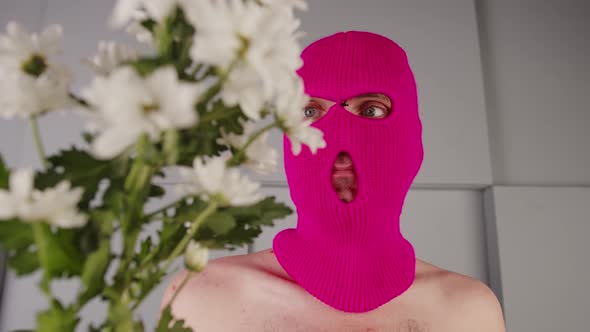 Anonymous Shirtless Man in Balaclava with Flowers