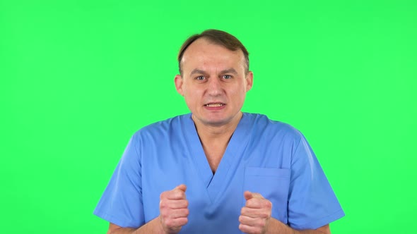 Medical Man Looking at Camera with Anticipation, Then Very Upset. Green Screen