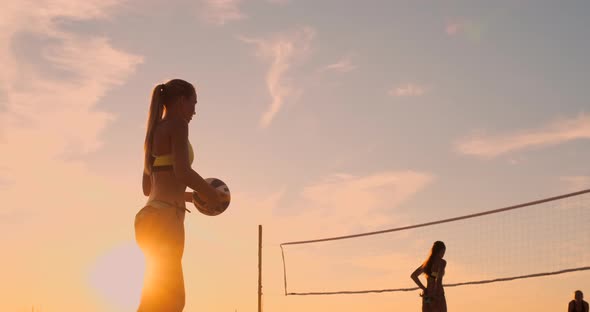 Beach Volleyball Serve - Woman Serving in Beach Volley Ball Game. Overhand Spike Serve. Young People