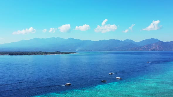 Aerial top view travel of tropical island beach voyage by blue lagoon and white sandy background of 