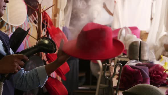 Mixed race woman working at a hat factory