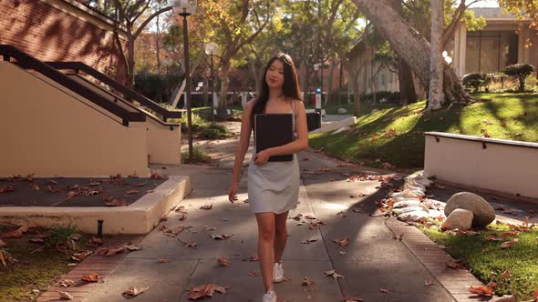 Asian female college student walking toward the camera