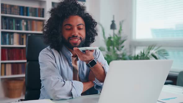 Successful Young Arabian Man Smiling Holding Mobile Phone Sending Voice Message