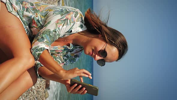 Hipster Girl With Phone on Beach