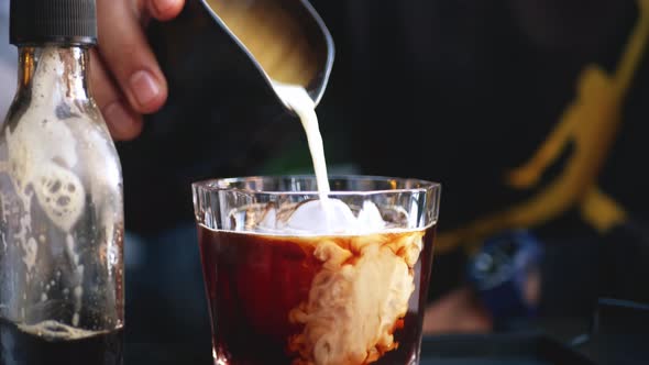 pouring milk into cold coffee  4K
