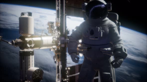 International Space Station and Astronaut in Outer Space Over the Planet Earth alt