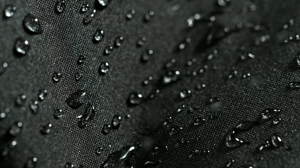 Super Slow Motion Shot of Water Droplets Splashing on Waterproof Cloth at 1000Fps.