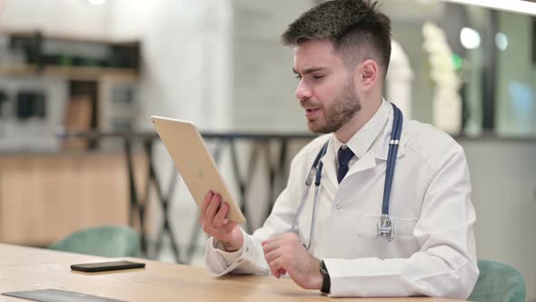 Young Doctor Doing Video Call on Tablet in Office