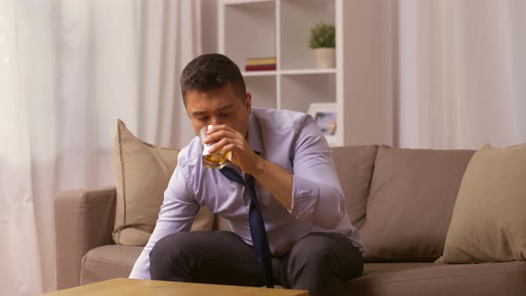 Alcoholic with Bottle Drinking Whiskey at Home