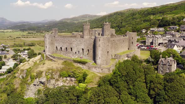 Harlech castle in North Wales, Gwynedd, UK, shot by drone to show proximity of the castle against th