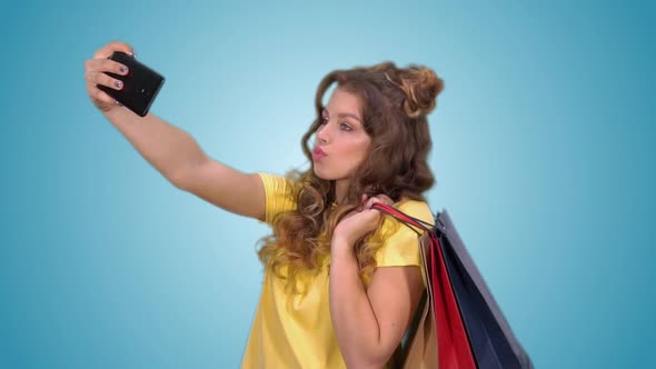 Happy Young Girl Making Selfie Holding Shopping Bags in Chickens