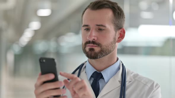 Portrait of Male Doctor Using Smartphone