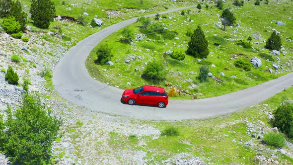 Aerial View of Road with Red Car in Beautiful Mountains in Komovi Montenegro