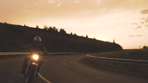 Man Riding Motorbike Against Beautiful Sunset Dramatic Sky Enjoying the Freedom