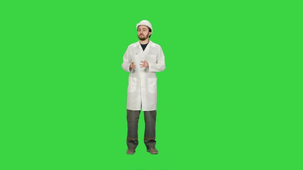 Building Architect Master Engineer Looking Paper Plan Under Development Area on a Green Screen