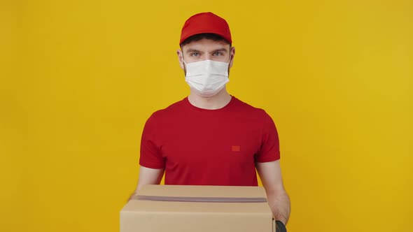 Courier in Protective Mask and Gloves Offering Parcel