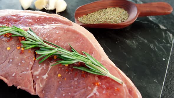 Raw sirloin chop, garlic, rosemary, and spice