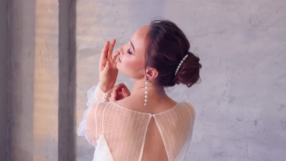 A Girl in a White Dress Professionally Poses Closeup with Her Back