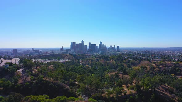 Slow rising drone shot of the city of Los Angeles Ca with clear blue sky and no clouds.