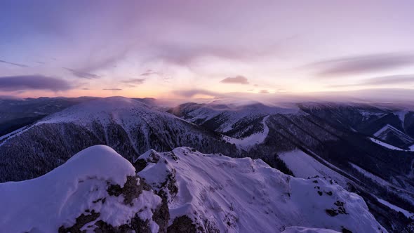 Colorful winter twilight after sunset over winter mountains zoom in