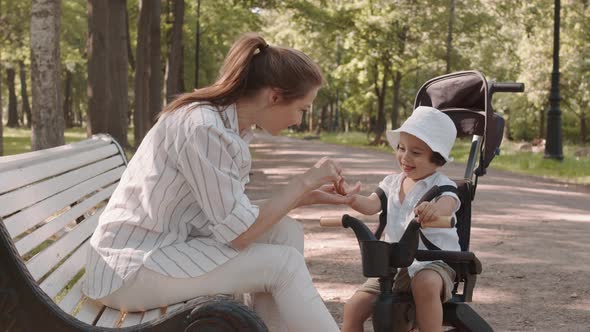 Woman Playing with Son in Park