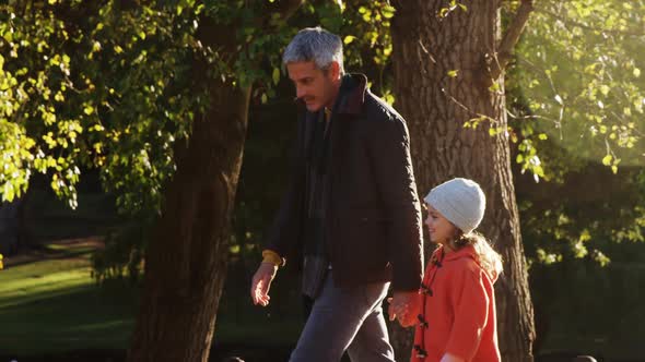 Girl walking with dad outdoors