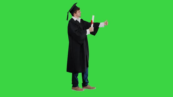 Graduation Student Showing Thumb Up on a Green Screen, Chroma Key.