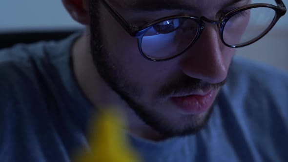 Portrait of Successful Young Bearded Man in Glasses Working with a Soldering Iron at His Working