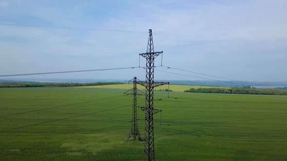 High-voltage Power Pylon on the Green Field