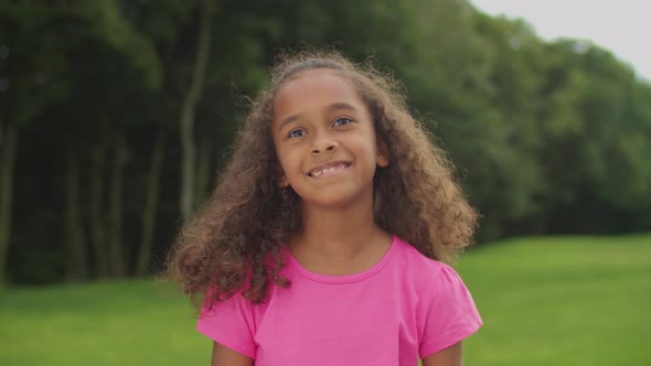 Lovely African Preadolescent Girl Smiling Outdoors