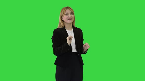 Happy Businesswoman Using Virtual Digital Screen in Front of Her on a Green Screen, Chroma Key.