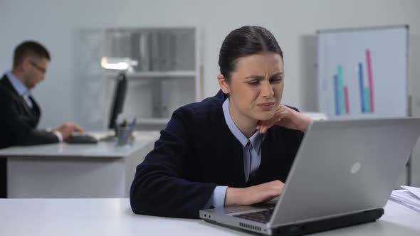 Female Manager Working on Laptop in Office Feeling Neck Pain, Sedentary Life