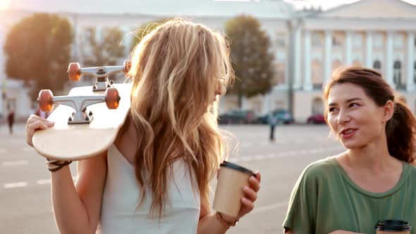 Two Fashion Hipster Girls at Outdoors Summer Party Pretty Teenage Friends with Skateboard in