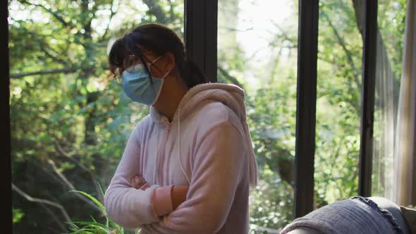 Asian girl wearing face mask with arms crossed