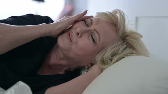 Sleepless Old Woman Having Headache in Bed