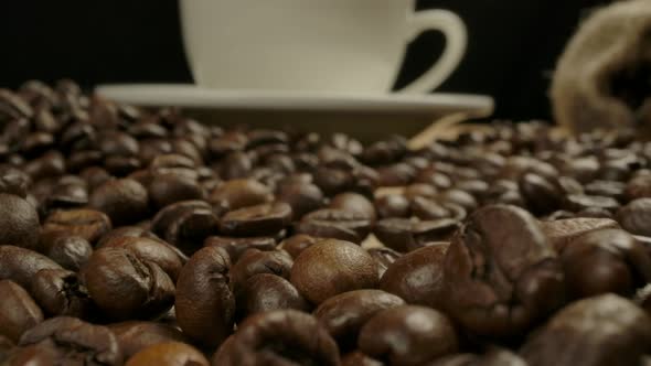 Camera Moving Throw Roasted Coffee Beans to White Classical Coffee Cup