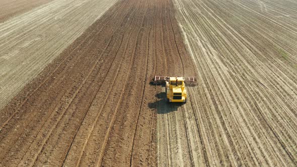 Tractor with Disc Harrows on the Farmland