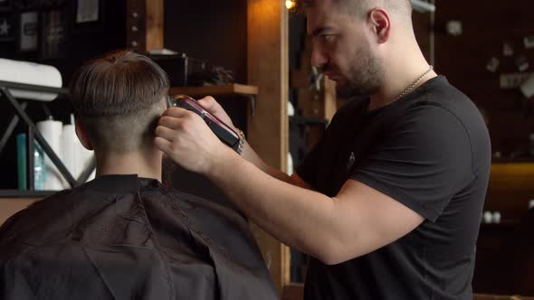 Barber Cutting Hair of Male Client