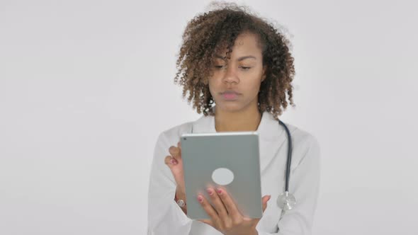 African Female Doctor Using Digital Tablet on White Background