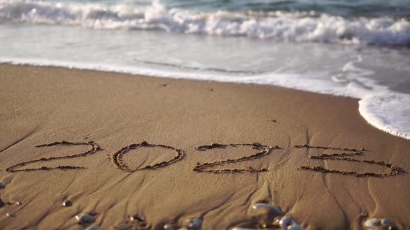 2023 Figures on Sandy Beach Happy New Year 2023 Number Hand Written in the Golden Sand on Beautiful