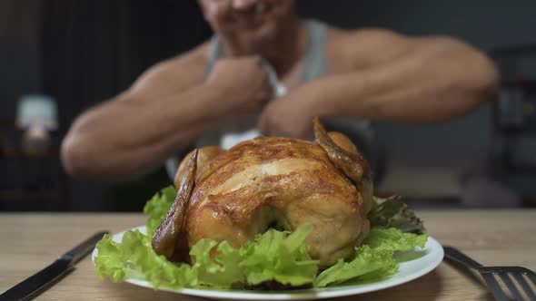 Man Preparing to Eat Greasy Fried Chicken Holding Knife and Fork Close-Up