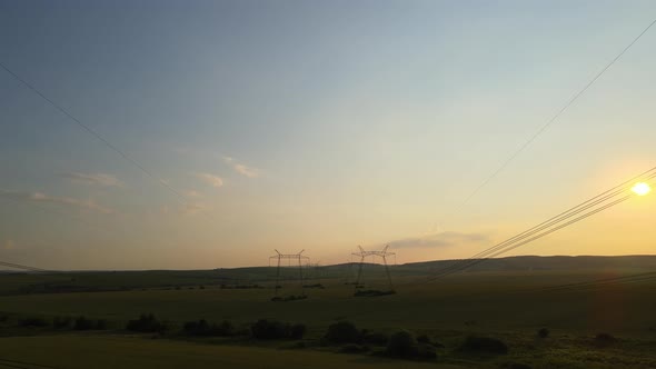 High Voltage Towers with Electric Power Lines at Sunset