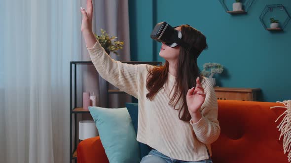 Young Girl Use Virtual Reality Headset Glasses at Home Play 3D Video Game Making Gestures with Hands