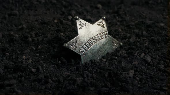 Rotating Around Sheriff's Badge In The Dirt