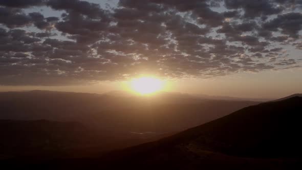 Sunset sky over mountain ridge in highland