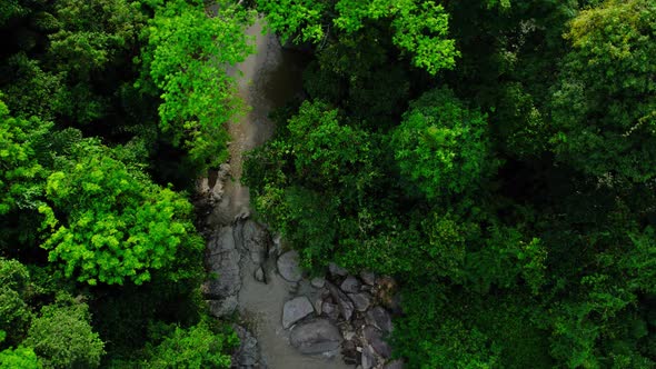 Flight over river between the mountains in tropical rainforest, Koh Samui, Thailand