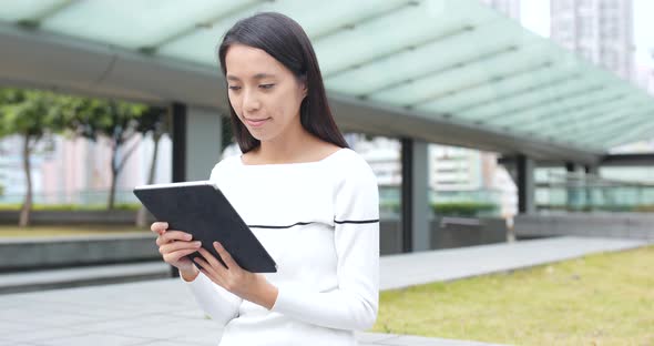 Woman use of digital tablet computer at outdoor