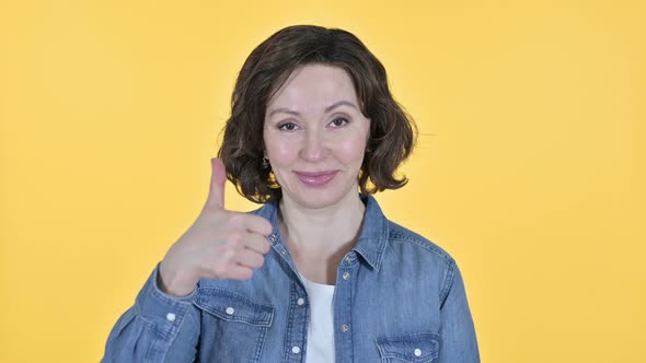 Thumbs Up By Positive Old Woman, Yellow Background