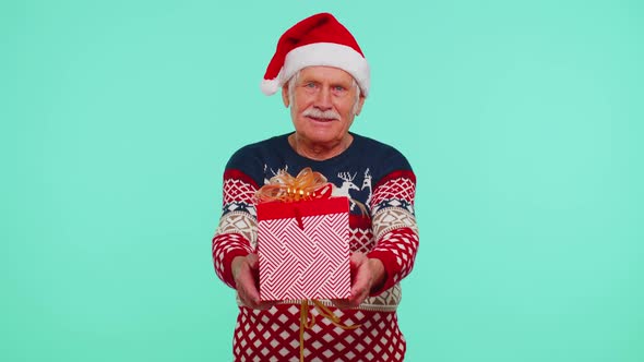 Senior Grandfather in New Year Sweater and Hat Presenting Christmas Gift Box Shopping Sale Holidays